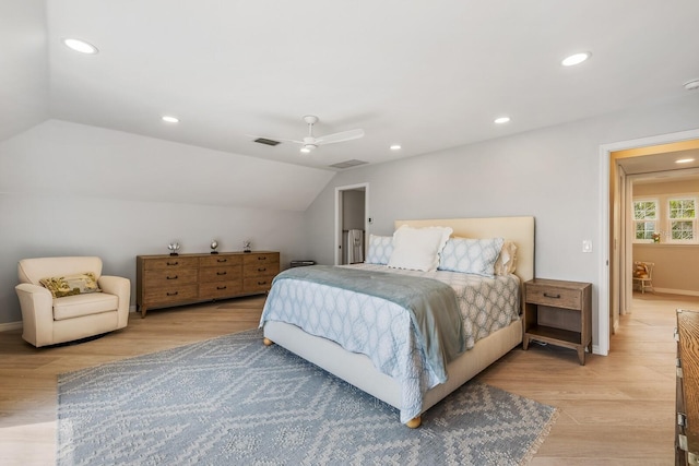 bedroom with ceiling fan, light hardwood / wood-style flooring, and vaulted ceiling