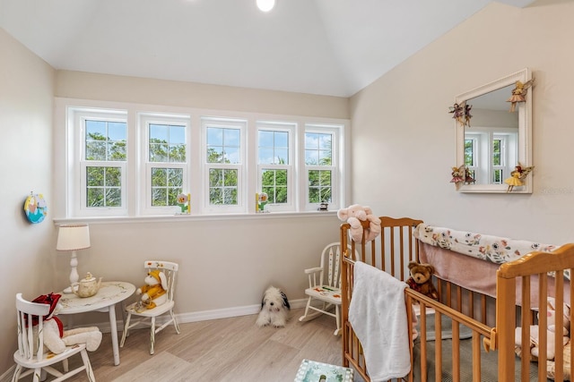22 Seawatch Dr, Boca Grande, FL 33921 - bedroom with wood finished floors, a crib, and lofted ceiling