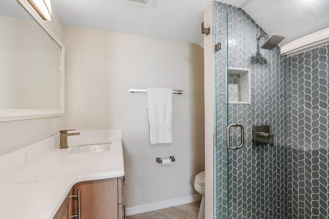 bathroom with walk in shower, wood-type flooring, vaulted ceiling, toilet, and vanity