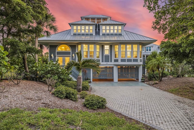 22 Seawatch Dr, Boca Grande, FL 33921 - back of property with a carport, a standing seam roof, driveway, and a metal roof