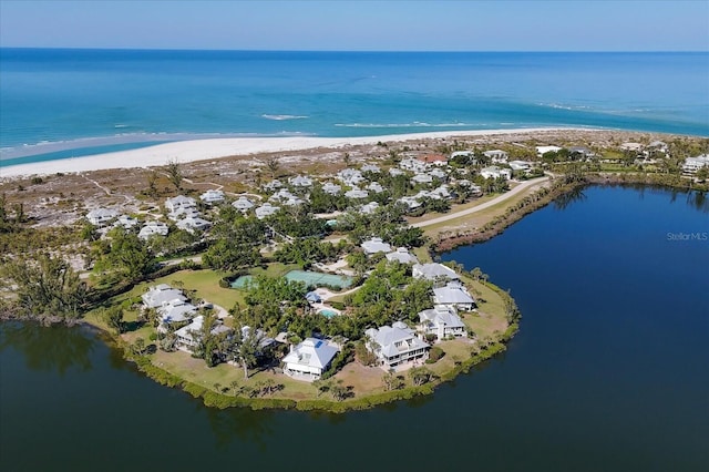 aerial view with a water view and a beach view