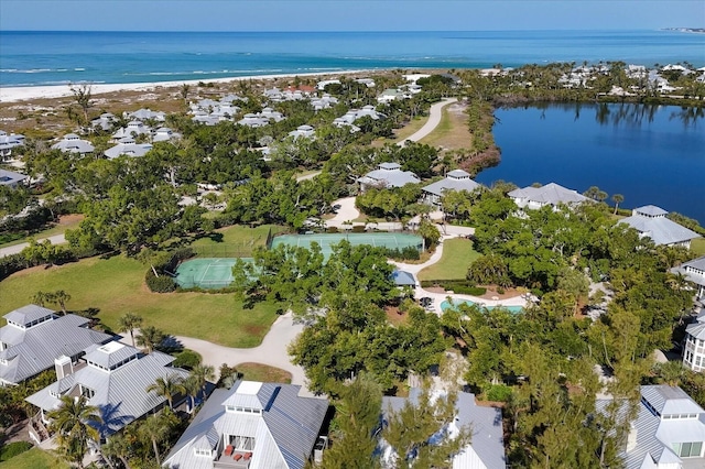 aerial view with a water view and a beach view