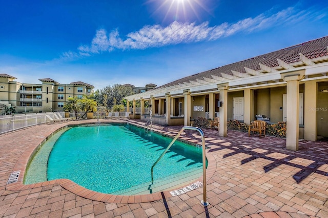 view of pool with a pergola and a patio