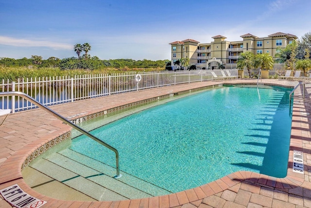 view of swimming pool with a water view