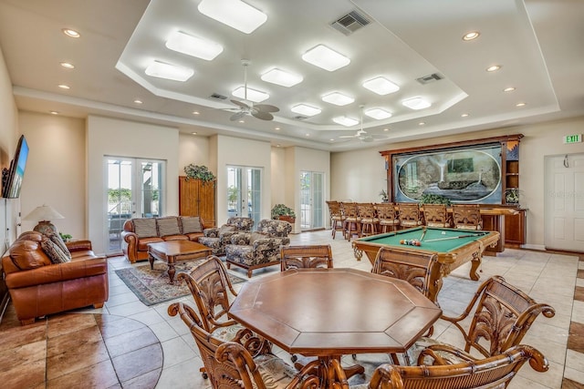 playroom with ceiling fan, french doors, a tray ceiling, light tile patterned flooring, and pool table