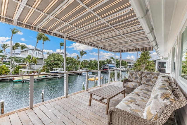 view of dock featuring an outdoor living space and a water view