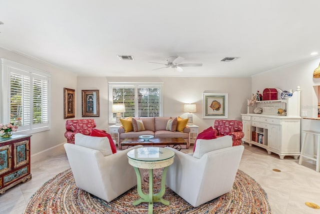 tiled living room with ceiling fan and ornamental molding