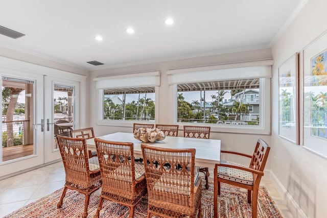 dining room with ornamental molding, light tile patterned floors, and french doors