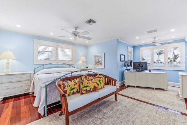 bedroom with multiple windows, ceiling fan, ornamental molding, and hardwood / wood-style flooring