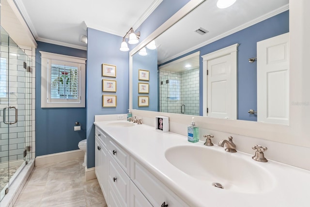 bathroom with tile patterned floors, vanity, crown molding, toilet, and a shower with shower door