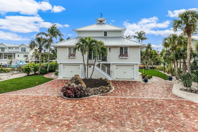 view of front of home featuring a garage and a front lawn