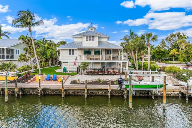 back of house with a balcony and a water view