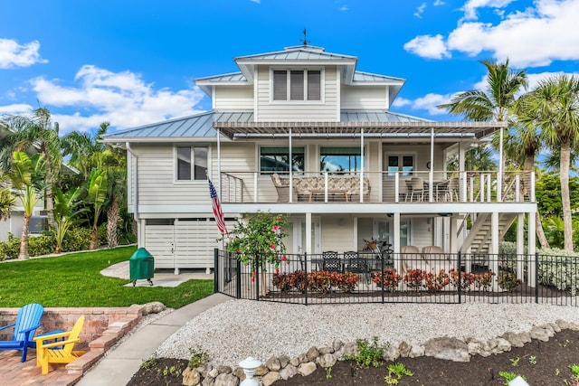 rear view of property featuring a lawn and a patio