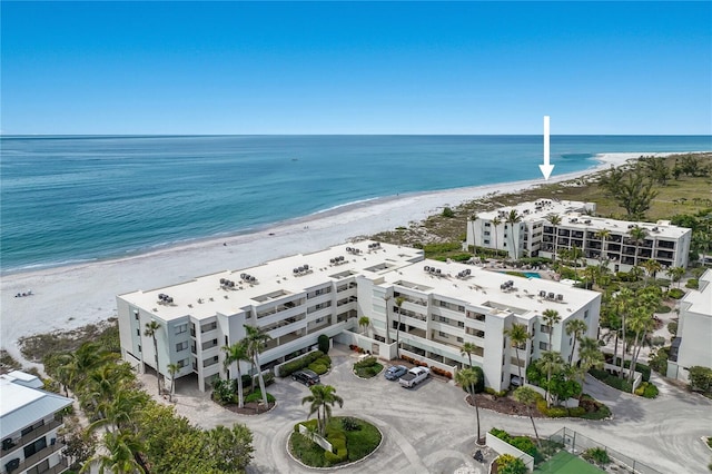 birds eye view of property featuring a view of the beach and a water view