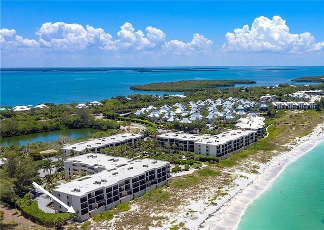 bird's eye view featuring a water view and a beach view