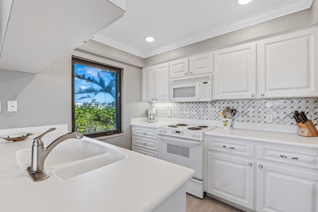 kitchen featuring white cabinets, white appliances, and sink