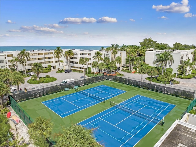 view of tennis court featuring a water view