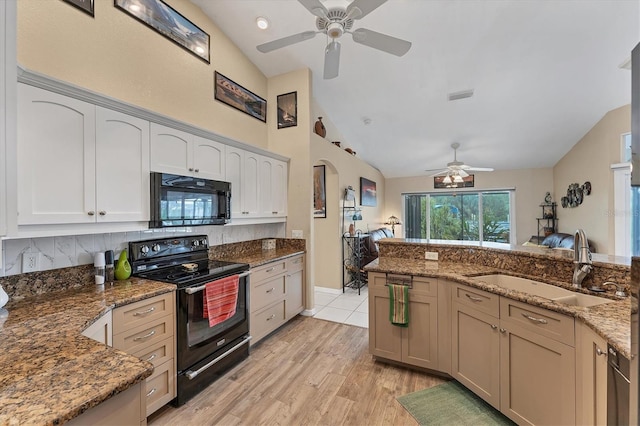 kitchen featuring sink, light hardwood / wood-style flooring, vaulted ceiling, and black appliances