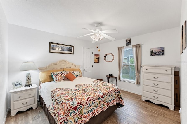 bedroom with ceiling fan and hardwood / wood-style floors