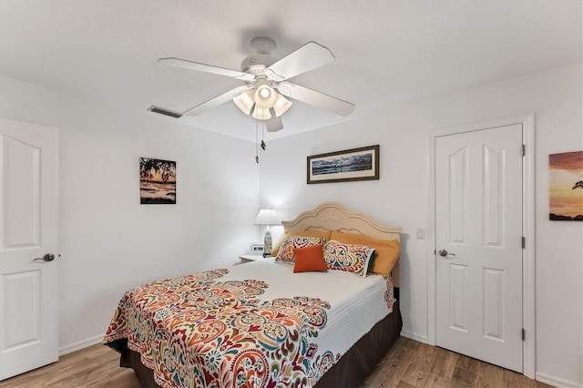 bedroom with ceiling fan and wood-type flooring