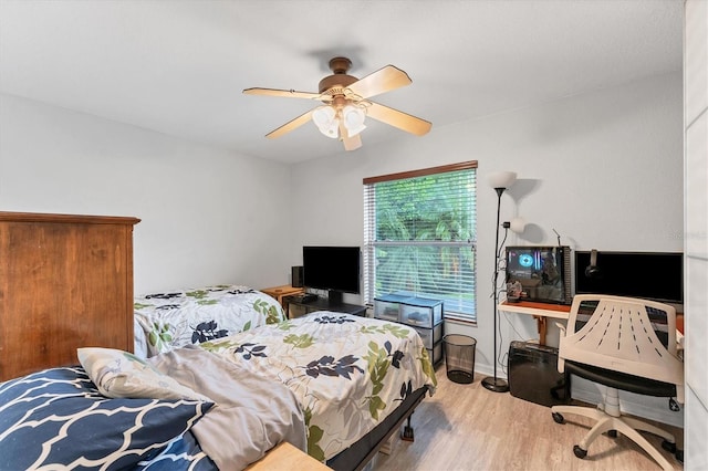 bedroom with light wood-type flooring and ceiling fan