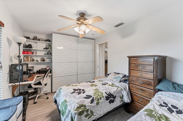 bedroom featuring hardwood / wood-style flooring and ceiling fan