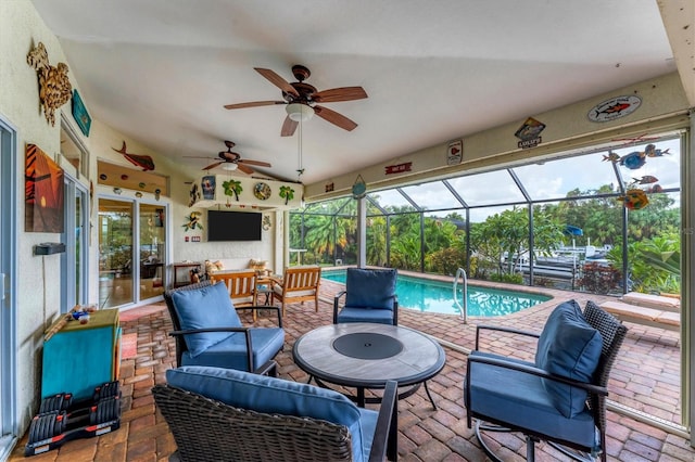 view of patio / terrace with ceiling fan and a lanai