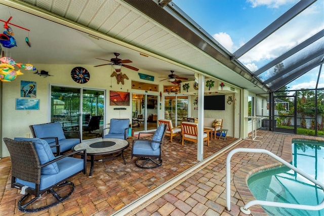 view of patio / terrace featuring ceiling fan and a lanai