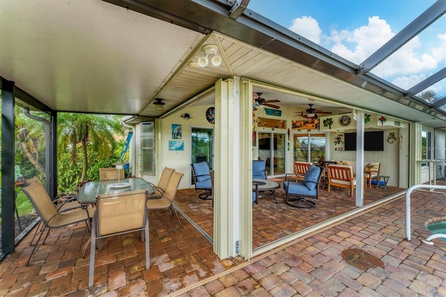 view of patio featuring glass enclosure and ceiling fan