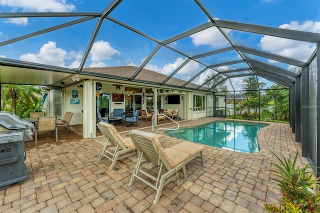 view of swimming pool with a patio area and a lanai