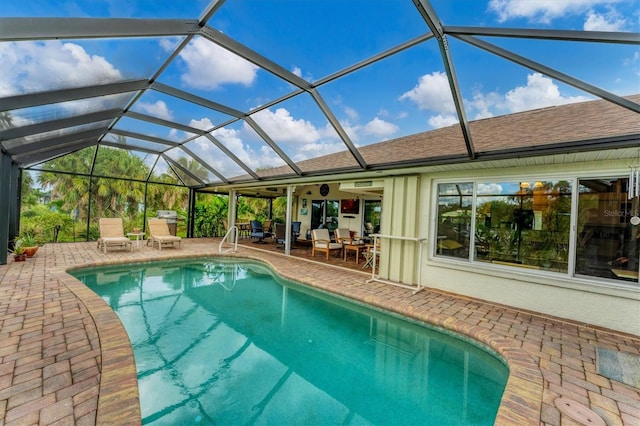 view of pool featuring a patio area and a lanai