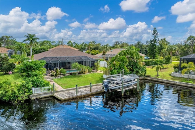 dock area with a water view, a lawn, and a lanai