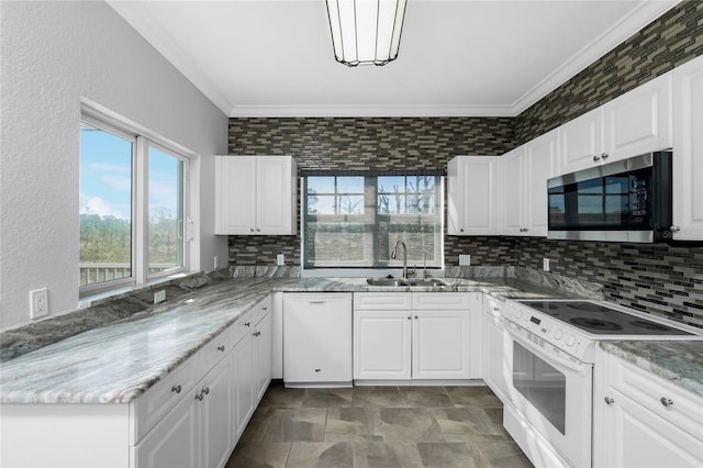 kitchen featuring white cabinetry, sink, crown molding, white appliances, and stone countertops