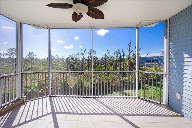 unfurnished sunroom featuring a wealth of natural light and ceiling fan