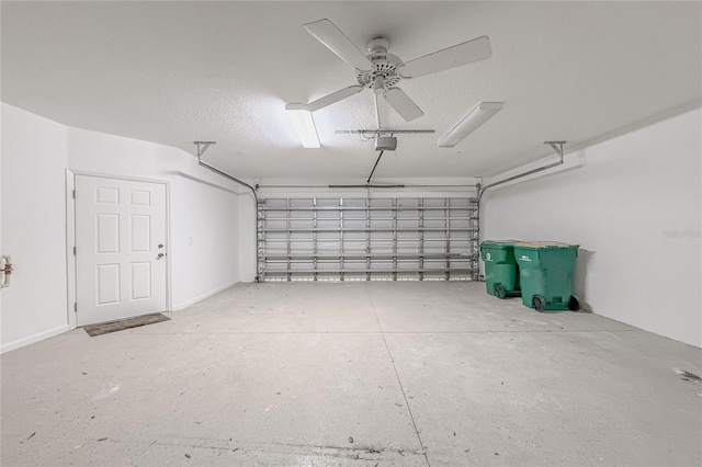 garage with a garage door opener and ceiling fan