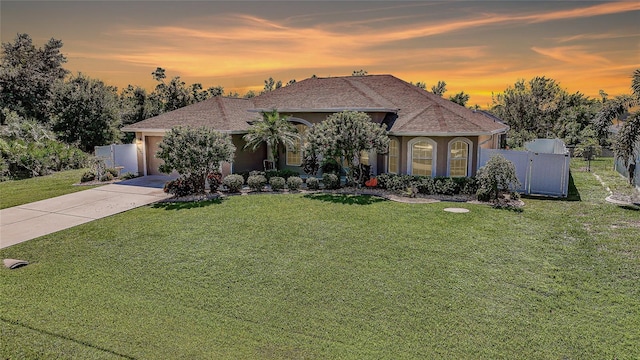 view of front facade featuring a garage and a yard