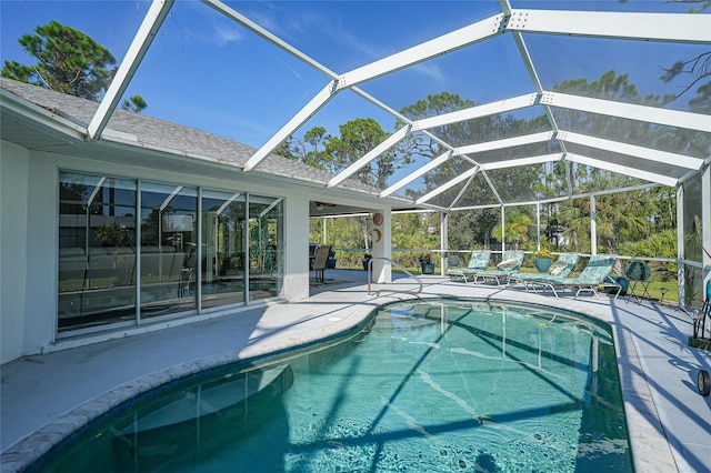 view of pool with a patio and a lanai