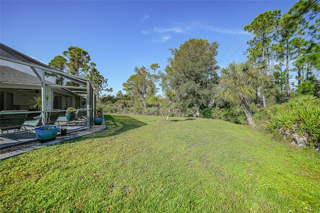 view of yard with a patio area and a lanai