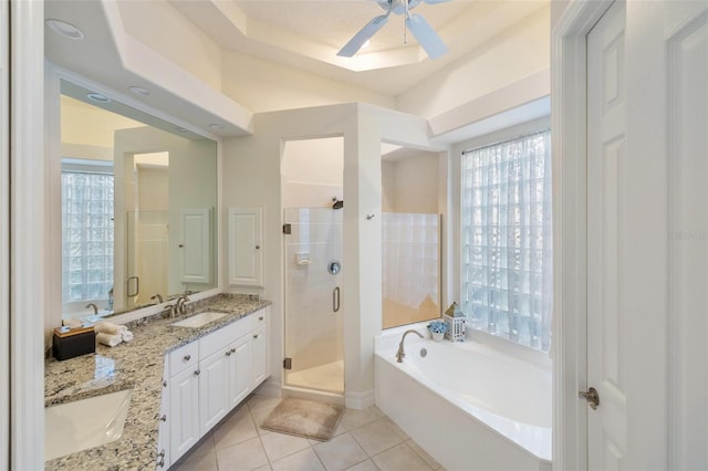 bathroom featuring vanity, ceiling fan, plus walk in shower, and tile patterned flooring