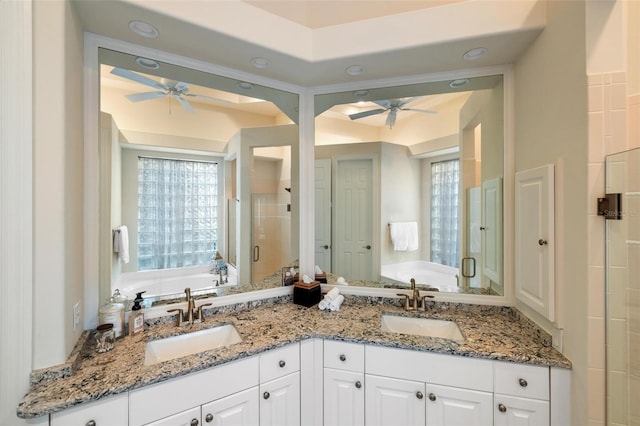 bathroom with vanity, ceiling fan, independent shower and bath, and a wealth of natural light