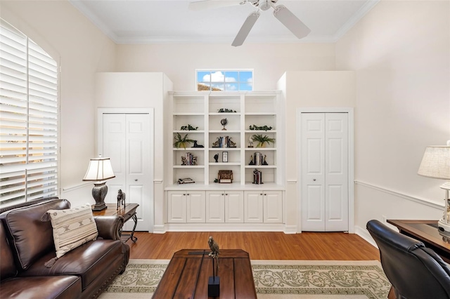 living room with ceiling fan, ornamental molding, light hardwood / wood-style flooring, and plenty of natural light