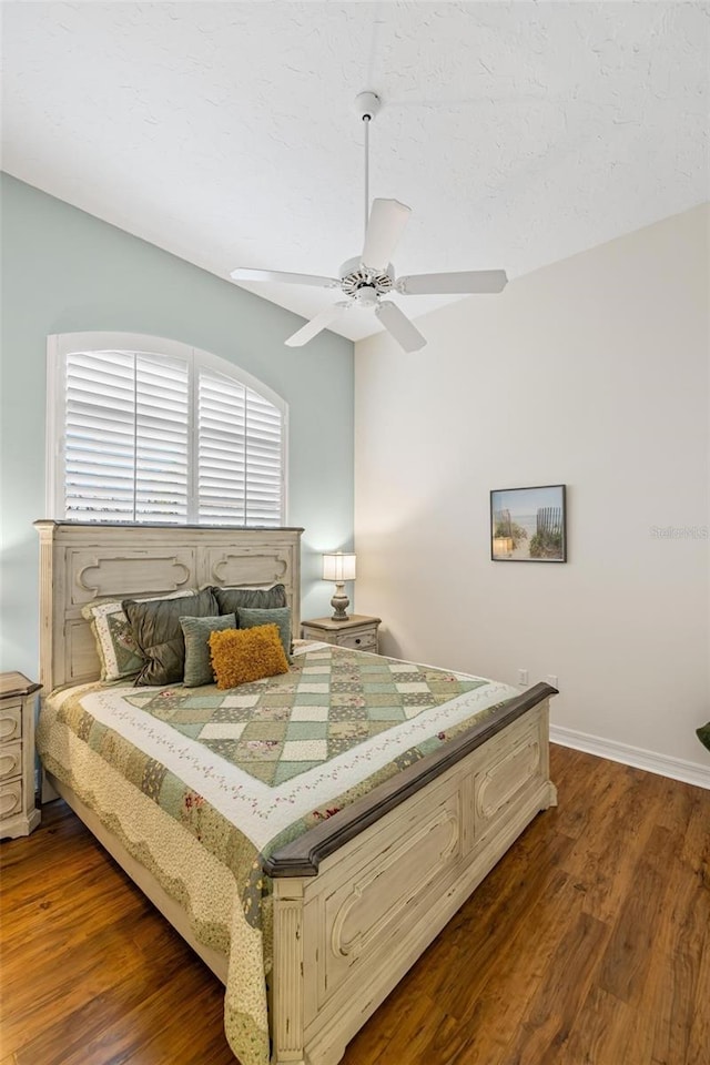 bedroom featuring dark hardwood / wood-style floors and ceiling fan