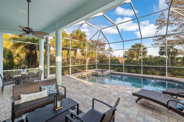 view of pool featuring a patio area, ceiling fan, an in ground hot tub, and glass enclosure