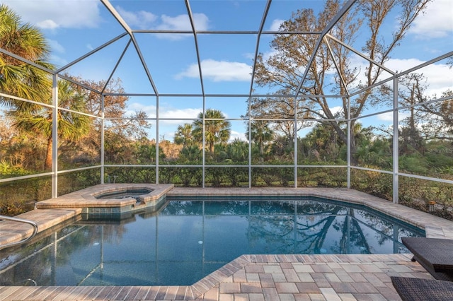 view of pool featuring an in ground hot tub and glass enclosure