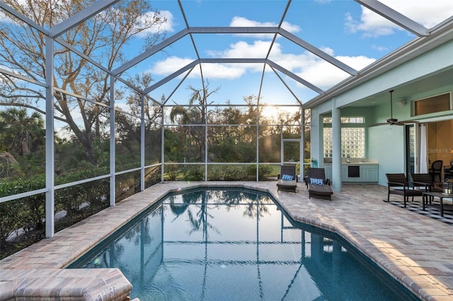 view of pool featuring a patio area, a lanai, and ceiling fan