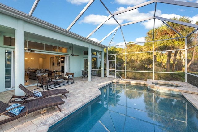 view of pool with an in ground hot tub, ceiling fan, a patio, and a lanai