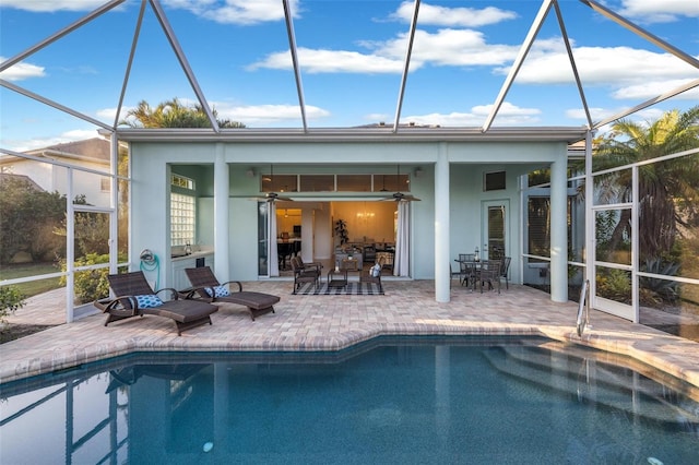 back of house featuring ceiling fan, a patio, and a lanai