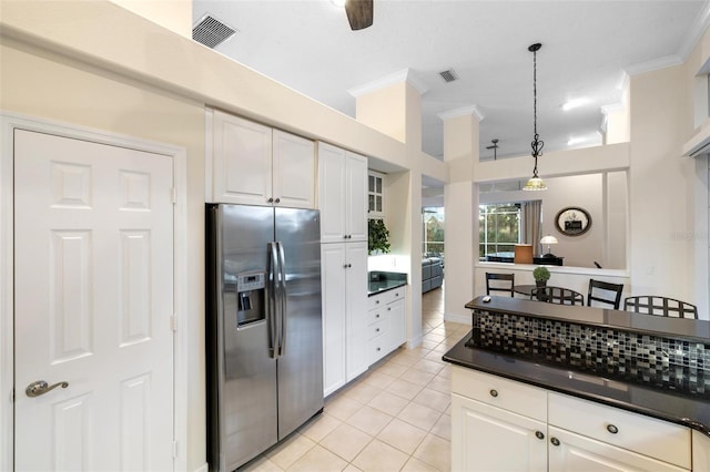 kitchen featuring stainless steel refrigerator with ice dispenser, ornamental molding, light tile patterned flooring, pendant lighting, and white cabinets