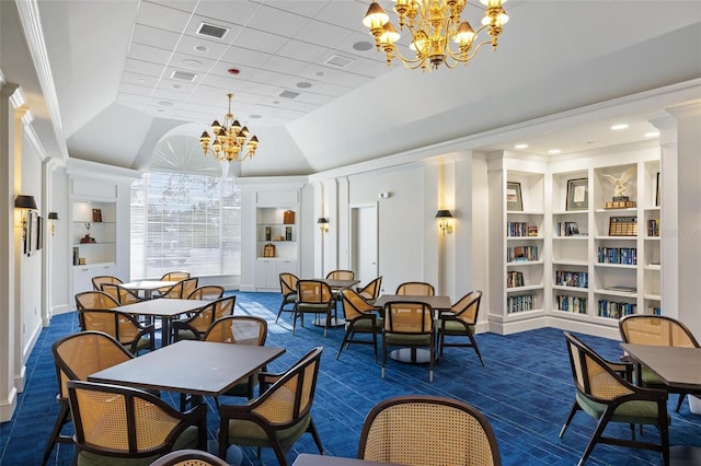 carpeted dining room featuring crown molding, a chandelier, and built in shelves