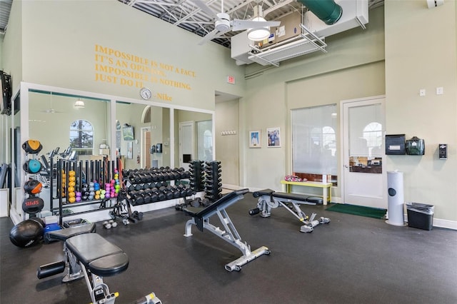 workout area featuring a towering ceiling